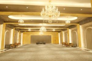 a large room with a stage and chandeliers at Rose Amer in Jaipur +88 photos