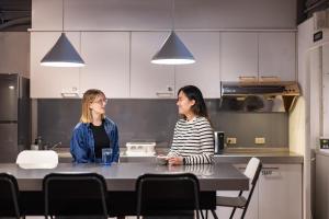 two women sitting at a table in a kitchen at MEANDER Taipei in Taipei +45 photos