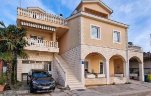 a car parked in front of a house at 3 Bedroom Lovely Apartment In Rogotin-Ploce in Rogotin
