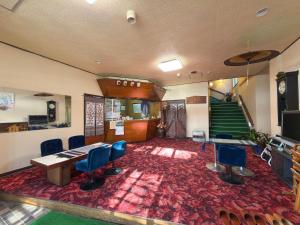 a room with chairs and a table and a staircase at 偕楽園 in Shirasaka +38 photos