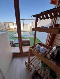 a balcony with a table and a bench with a view at اكواخ اثينا الفندقية in Jeddah +7 photos