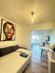 a bedroom with a bed and a painting on the wall at Vista Bayahibe Paradise in Bayahibe