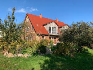 a large brick house with a red roof at Andrea in Timmendorf