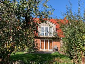 a brick house with a window and a balcony at Andrea in Timmendorf +7 photos