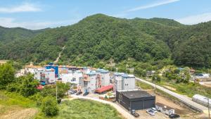 an aerial view of a village in the mountains at Chuncheon Vishop Pension in Chuncheon