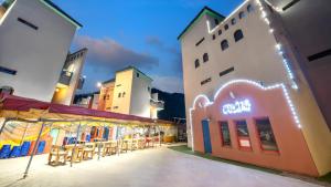 a group of buildings with tables and chairs outside at Chuncheon Vishop Pension in Chuncheon