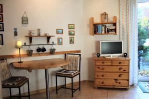 a dining room with a table and a television at Lütt Eddy in Kaltenhof