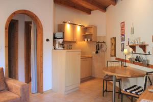 a kitchen and dining room with a table and a refrigerator at Lütt Eddy in Kaltenhof