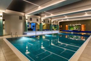 a large swimming pool in a hotel room at Hotel Wellness & Spa Nowy Dwór in Rzeszów +91 photos