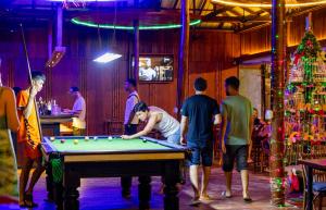 a group of people standing around a pool table at Onederz Koh Rong Sanloem in Koh Rong Sanloem +34 photos