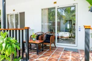 a patio with a table and chairs on a porch at Onederz Koh Rong Sanloem in Koh Rong Sanloem