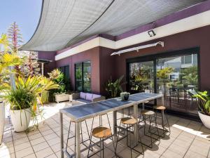 a patio with a table and some plants at ibis Newcastle in Newcastle