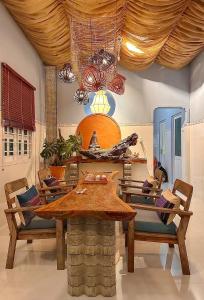 a dining room with a wooden table and chairs at Entire Garden House in Con Dao ! 3BR & 4WC ! Private Yard with Washer & Dryer in Con Dao