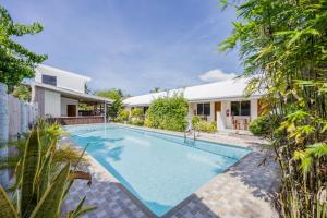 an image of a swimming pool in the backyard of a house at Badi's Place in Moalboal