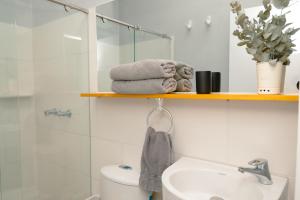 a bathroom with a shower and a toilet and a sink at El Caracol in Popayan +172 photos