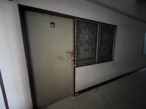 a door with a gate in a building at room 102 in Wanna Apt in Pattaya