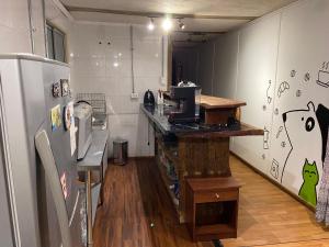 a kitchen with a counter and a refrigerator at Departamento Terraza in Molina