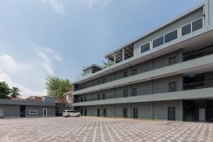 a building with a car parked in front of it at Urbanview Hotel AnD Lampung by RedDoorz in Lampung