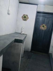 a room with a table and a wooden door at Chill corner in Ahangama
