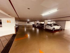 a parking garage with two cars parked in it at Sea View Studio in Pattaya South