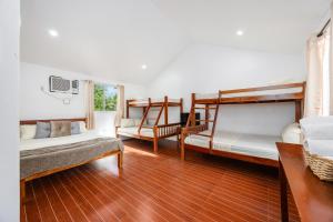 a room with two bunk beds and a couch at Badi's Place in Moalboal +63 photos