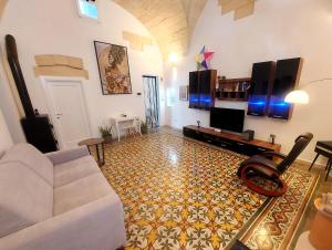 a living room with a couch and a tv at Il Melograno in Cavallino di Lecce