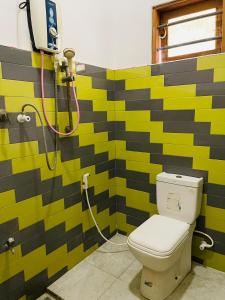 a bathroom with a toilet and a shower at Golden Palace Yala in Tissamaharama +40 photos