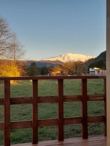 a view of a field from a porch at Cabaña Bellavista in Manzanar +8 photos