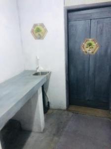 a bathroom with a sink and a blue door at Chill corner in Ahangama +9 photos