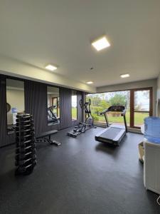a gym with several treadmills and machines in it at Cascadas Hotel in Puerto Octay