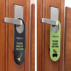 two pictures of a door with a sticker on it at Urbanview Hotel SLIP Pringsewu by RedDoorz in Margakaya