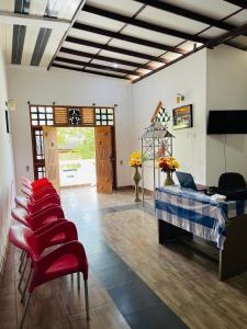 a room with a bed and a row of red chairs at Golden Palace Yala in Tissamaharama