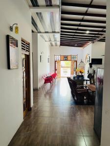 a living room with red chairs and a table at Golden Palace Yala in Tissamaharama