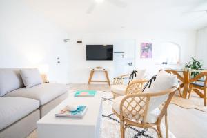 a living room with a couch and a table at The Chelsea Beachside Apartment in The Entrance