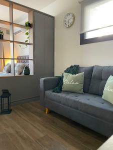 a living room with a couch and a clock on the wall at Rosario SJ Loft Studio in Rosario