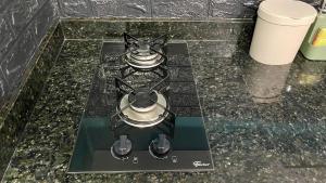 a stove top with two burners on a counter at Compact Studios Close to Shopping Centers, Downtown, Arena, Airport in Manaus +62 photos
