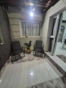two black chairs in a room with a window at Pardo Mza in Godoy Cruz