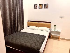 a bedroom with a bed with a black curtain at Vibes stay in 3 in Hyderabad