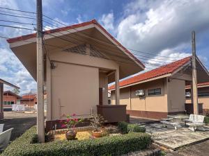 a house with awning on the side of it at Chumphon Park Resort in Chumphon
