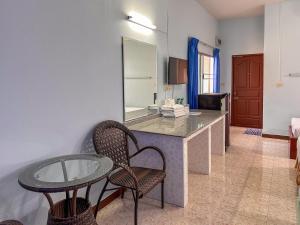a room with a table and chairs and a mirror at Chumphon Park Resort in Chumphon +42 photos