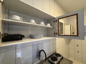 a kitchen with a sink and a mirror at Complete and well located stay! in Barreiras +13 photos
