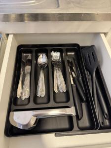 a black tray with utensils on a counter at Complete and well located stay! in Barreiras