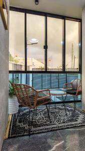 two benches and a glass table in a building at Jayhaven Crystal Serviced Apartment in Uyo