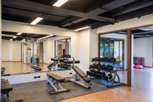 a gym with tread machines and a mirror at Wyndham Garden Samui Wing in Chaweng
