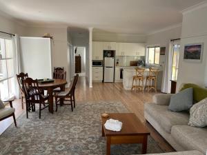 a living room with a couch and a table at Moruya Heads Constable Street in Moruya Heads