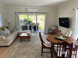 a living room with a table and a couch at Moruya Heads Constable Street in Moruya Heads