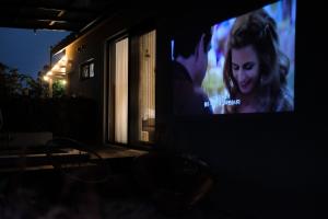 a tv screen with a man and a woman on it at 바티하우스 in Ara-ri