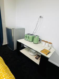 a room with a table with cups and a lamp at Room with en-suite bathroom in Kaiapoi