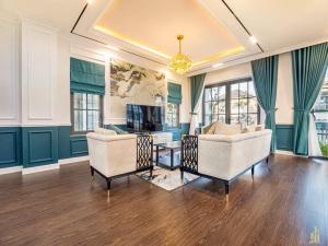 a living room with two chairs and a table at Phan Thiết Nova World Malibu 2 Villa in Phan Thiet