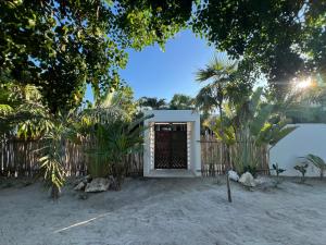a small house with a door on the beach at Nomads Kite House in El Cuyo